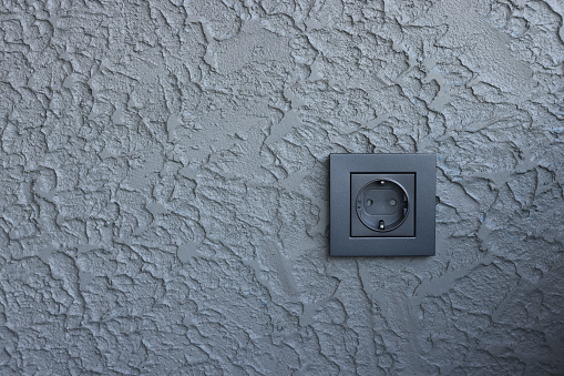 Electrical Outlet on the Gray Wall