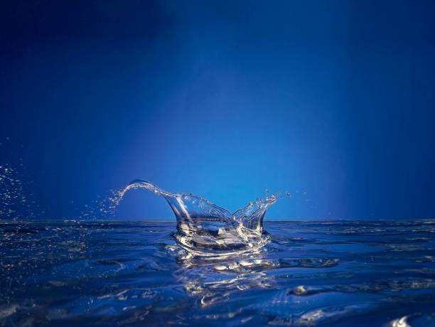Close up of splashing water droplet. Blue Background