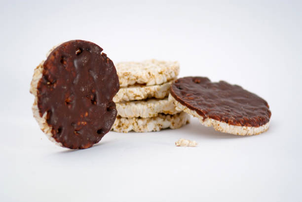 Assortment of ingredients on puffed rice cakes isolated on white background.