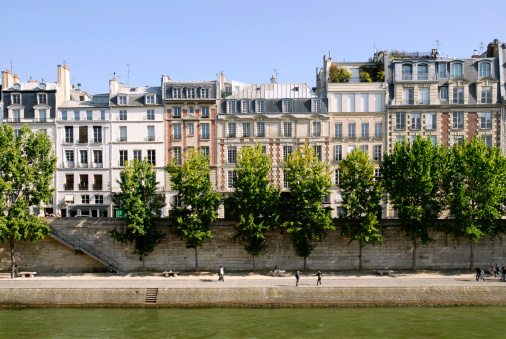 Famous quay of Seine in Paris with trees and buildings