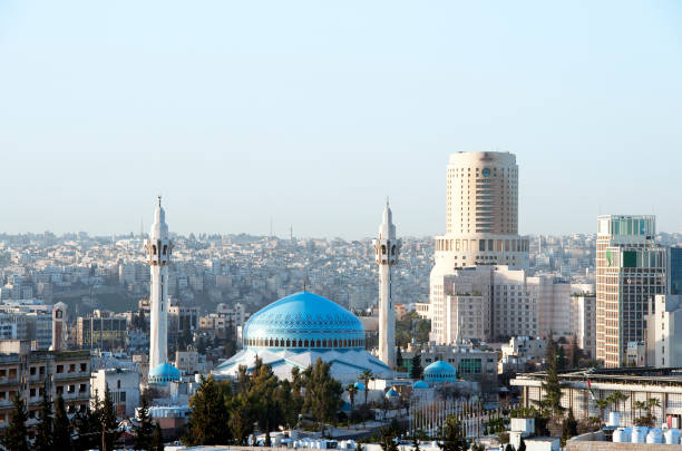 Islamic Mosque minarets, domes and temples proliferate on the skyline around Amman, Jordan stock photo