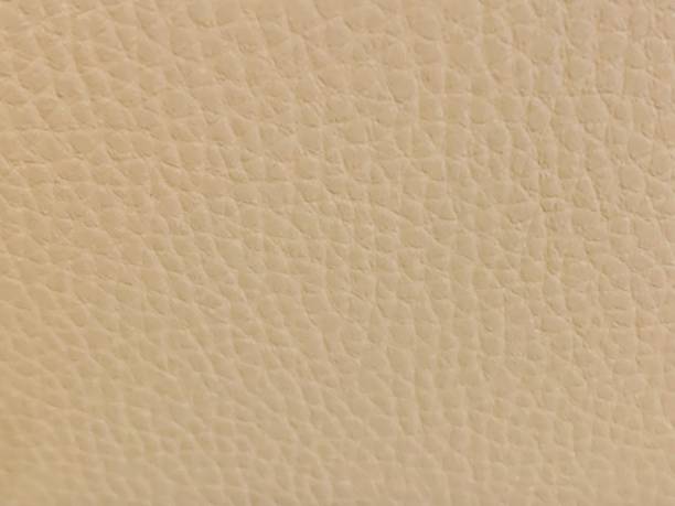 Background of beige faux leather Background of beige faux leather fake leather stock pictures, royalty-free photos & images