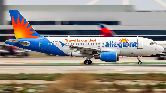 Los Angeles international Airport, CA, United States - 04 December 2022: Allegiant Airbus A319 (N324NV) running down runway 24L for take off.
