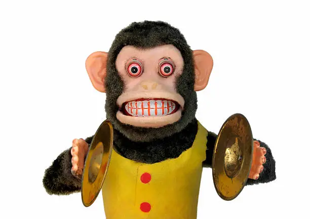 Vintage mechanical monkey with cymbals showing teeth