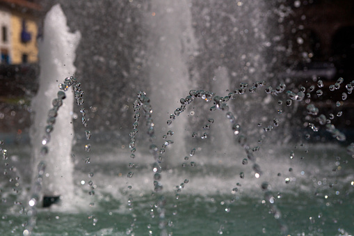 Water Fountain close up with a bigger fountain in the background