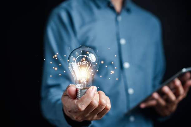 istock Hand man holding illuminated lightbulb, idea, innovation and inspiration with glowing virtual brain, smart intelligent creativity with bulbs, Motivation and innovation concept. 1470913827