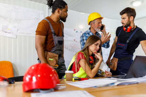 istock Young Construction Workers and Their Senior Colleague are Analyzing Construction Plans in the Office. 1470916016