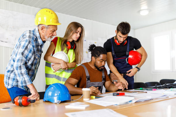 istock A Senior Construction Worker is Analyzing Project Plans with Young Coworkers. 1470916311