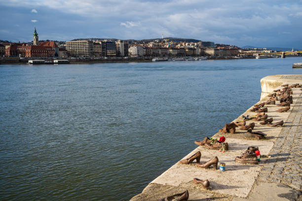 Shoes on the Danube Bank. Memorial to the Hungarian Jews, the victims of the Holocaust, executed along riverbank during WWII. Budapest, Hungary - February 2, 2023.