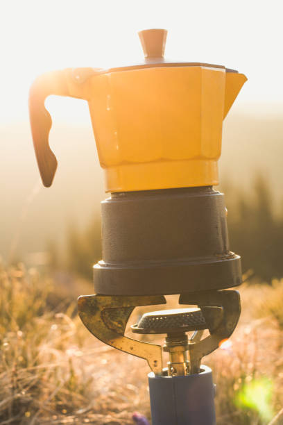 Close up camping kettle on gas burner in sunshine concept photo