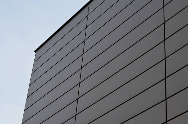 istock cladding of a building with a expanded metal lattice structure. galvanized gray nets protect the industrial building. Blue sky in contrast to a silver background, wall, corner, slanted, sheet metal 1470917519