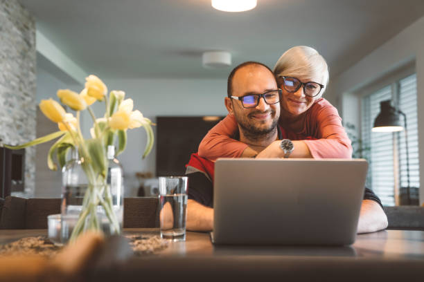 istock Wife hugging his husband while he works from home on the laptop 1470918253
