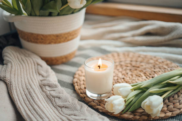 istock Burning candle and tulips in home interior 1470922484