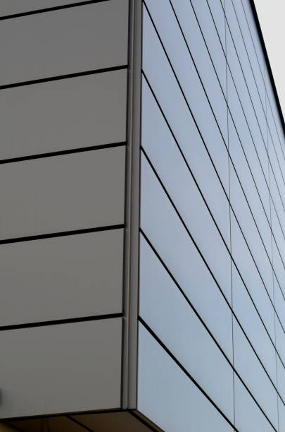 istock cladding of a building with a expanded metal lattice structure. galvanized gray nets protect the industrial building. Blue sky in contrast to a silver background, wall, corner, slanted, sheet metal 1470922912