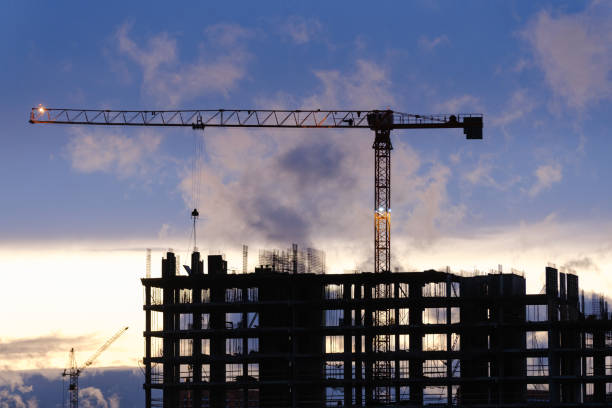 istock Tower crane, workers work at construction site. Process of building new houses 1470925470