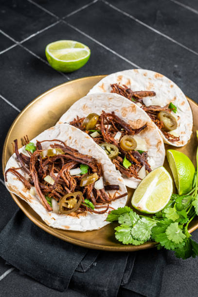 istock Mexican Beef Barbacoa Tacos with Cilantro and Onion. Black background. Top view 1470925691