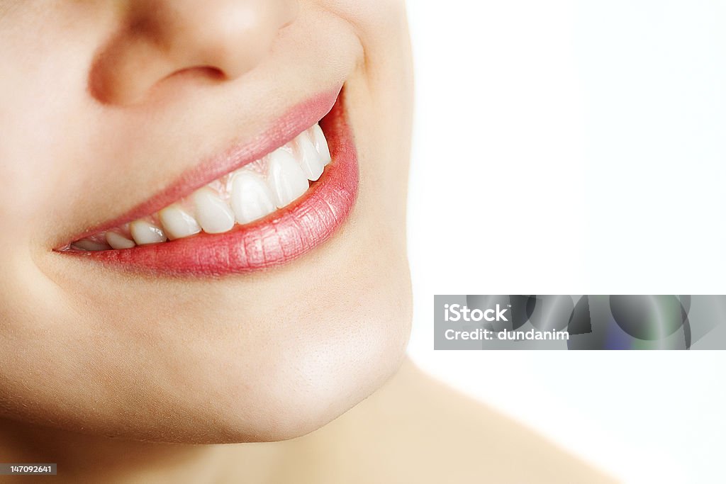 Fresh smile of woman with healthy teeth Fresh smile of woman with healthy teeth over white Adult Stock Photo