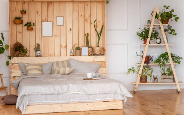 istock Bedroom in rustic style. Scandinavian interior with large bed with wooden wall. Botanical apartments 1470930883