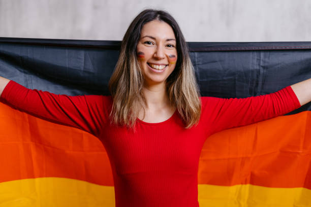 istock Young Woman Holding Up A German Flag 1470930926
