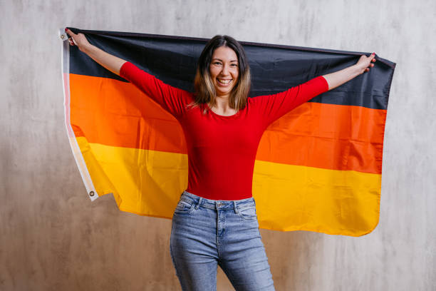 istock Young Woman Holding Up A German Flag 1470931370