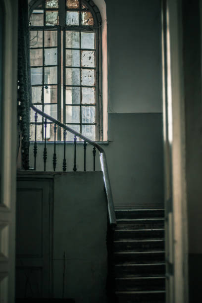 istock Old hallway with stairs and window 1470932119