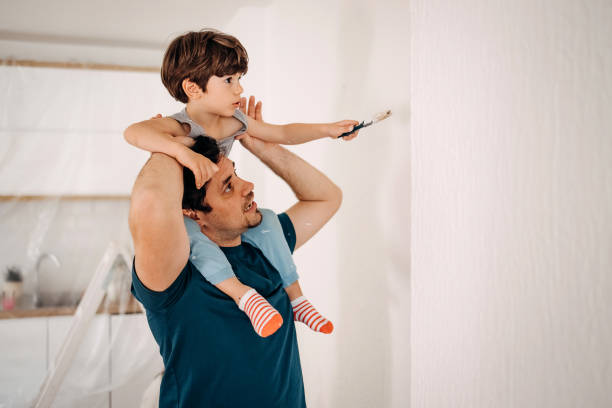 istock Father and son painting the walls 1470933108