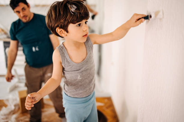 istock Kid painting a wall 1470933296