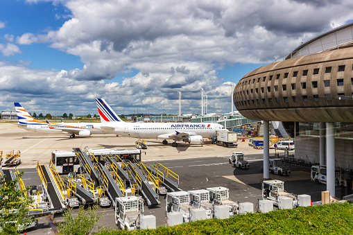 Paris, France - June 6, 2022: Airplanes at Paris Charles de Gaulle airport (CDG) terminal 2 in France.