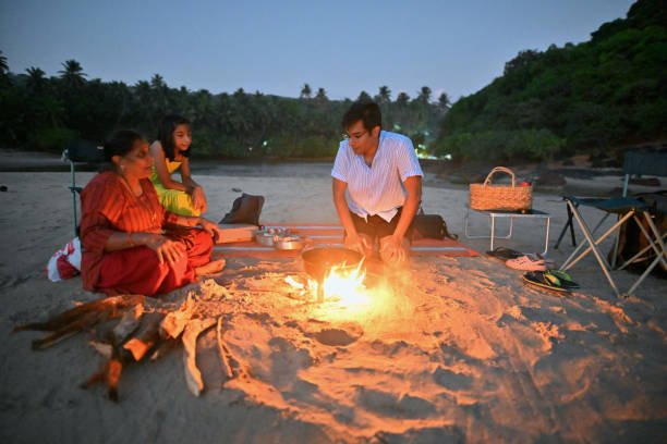 istock Three generation family having Barbeque on the beach at twilight 1470934146