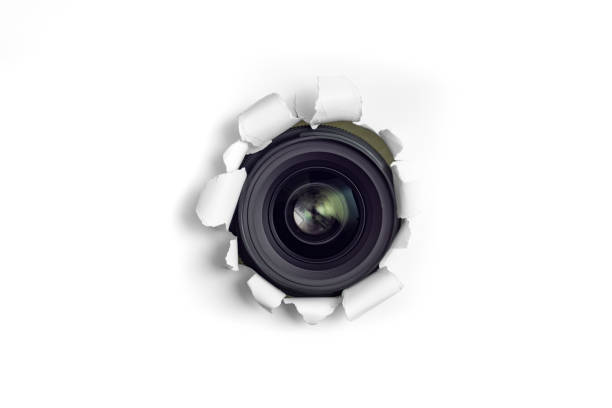 istock Camera lens taking pictures thru a torn hole 1470934423