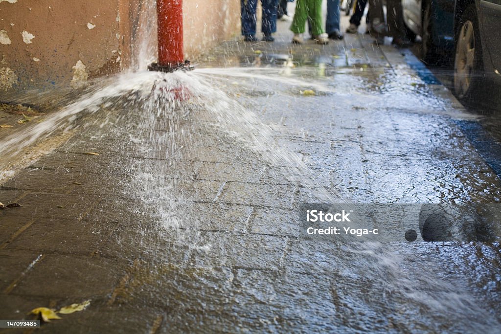 Water waste. Burst pipe in the street. Exploding Stock Photo