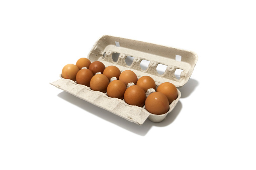 An egg carton container, with a dozen brown eggs. Isolated on a white background. Eco products concept.
