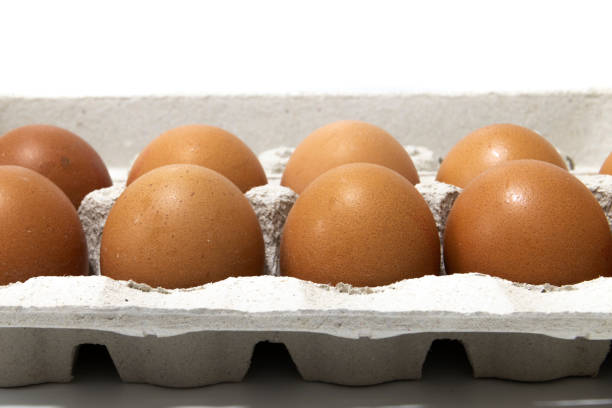 istock An egg carton container, with a dozen brown eggs. Isolated on a white background. 1470940021