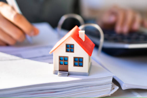 istock Person Hand Doing Property Tax Calculation Using Calculator 1470940499