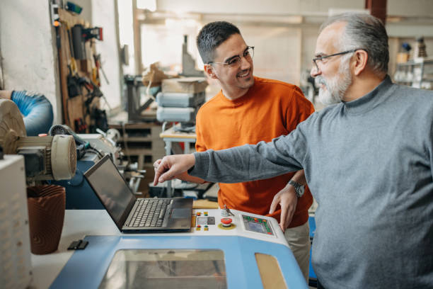 istock Young student taught by mid adult professor on laser cut operating 1470941408