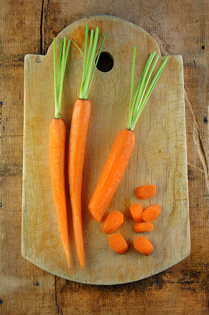 istock Carrots on Wooden Cutting Board 147094220