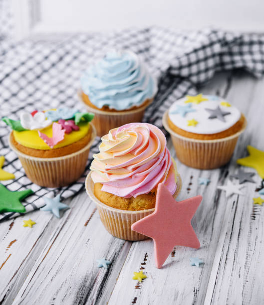 istock Multiple colorful nicely decorated muffins on a wooden background 1470942536