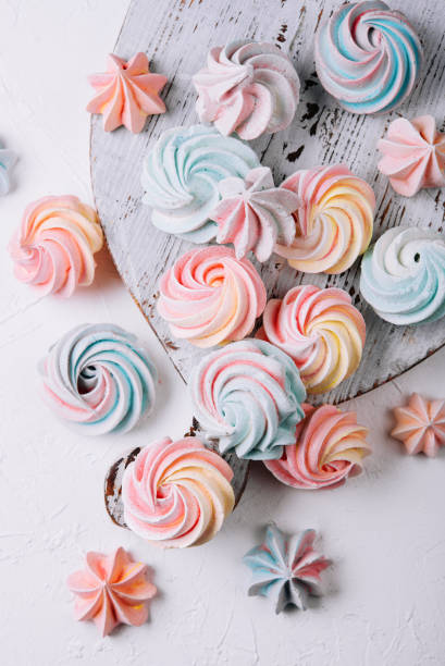 istock Multicolored meringue on wooden tray top view 1470943846