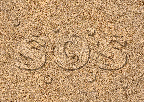 istock SOS written in water letters on a real sand texture, water drops. Symbolic representation. Climate change and lack of water 1470946780