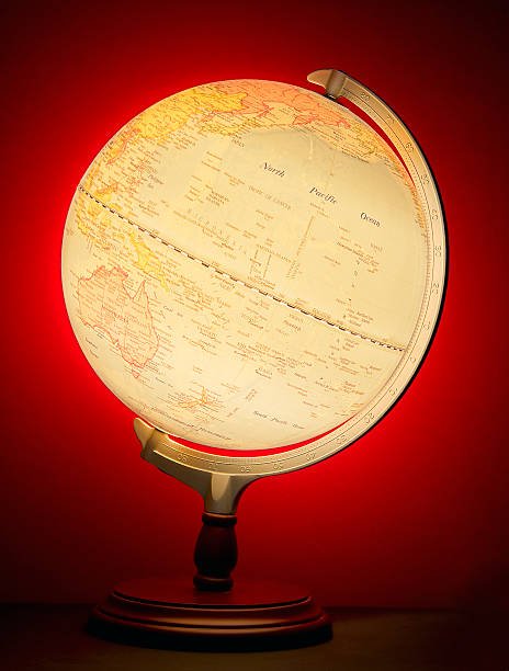 World Globe An illuminated globe of the Earth against a red background. north pacific ocean globe stock pictures, royalty-free photos & images