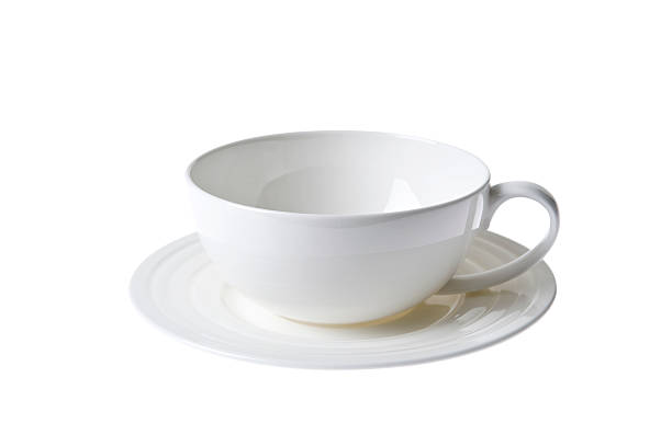 white china cup and sauser set isolated stock photo
