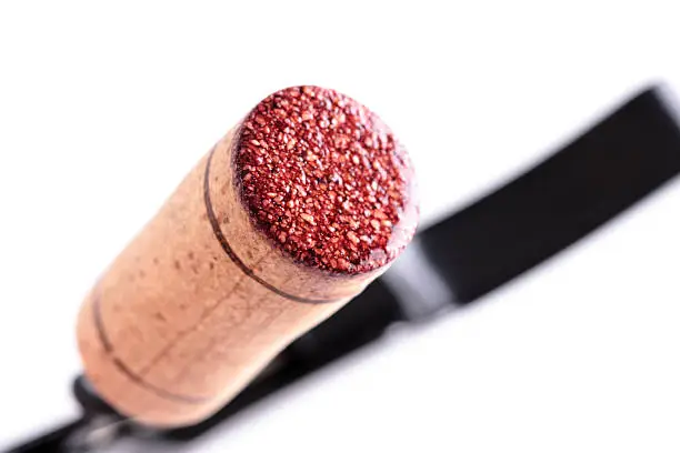 red wine cork on an opener, isolated