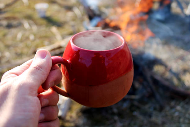 istock A hand holding a red mug with coffee in it. 1470952821