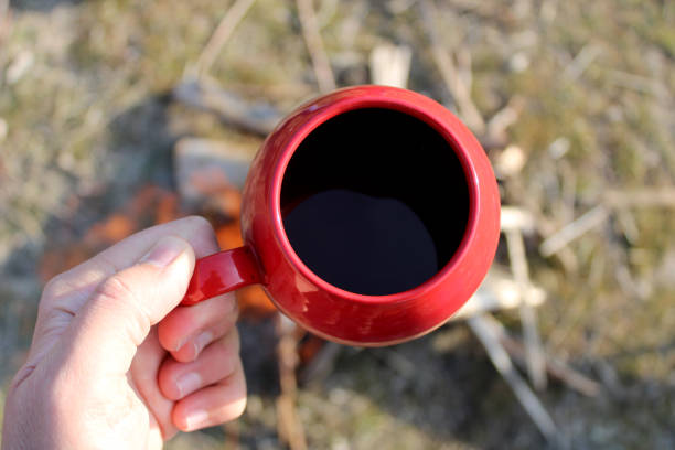 istock A hand holding a red mug with coffee in it. 1470953164