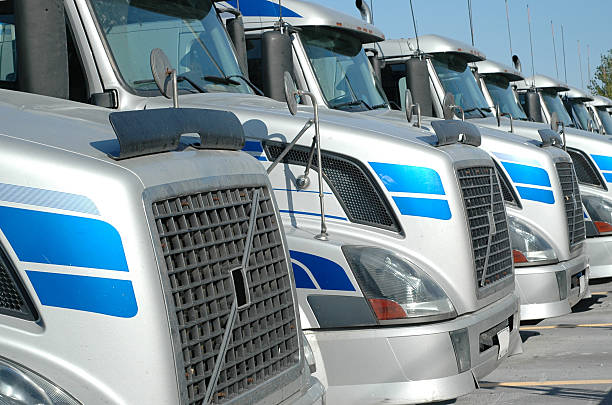 istock Row of 6 silver semi-trucks looking down from the grills 147095349