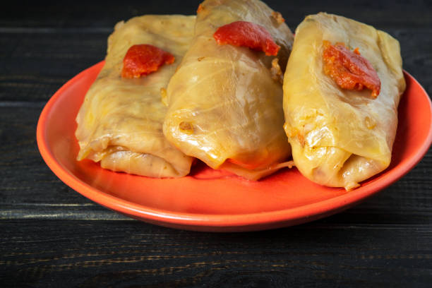 istock Cabbage rolls with beef, rice and vegetables on the plate. Stuffed cabbage leaves with meat. Black vintage table 1470954582
