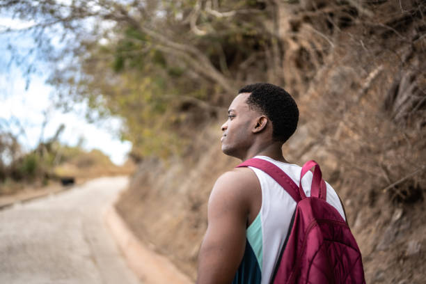 istock Young man looking around during hike outdoors 1470956296