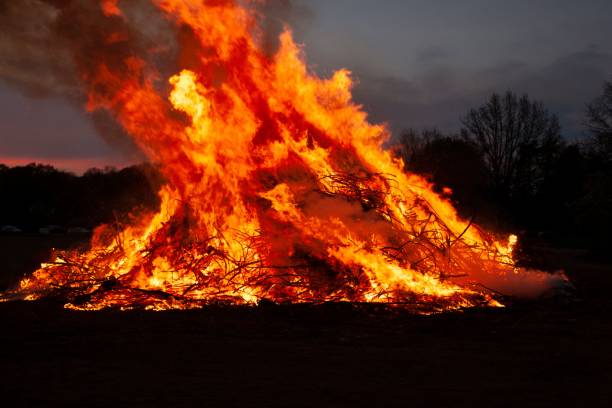 istock a bonfire is lit in the night sky at dusk with thick orange flame 1470956927
