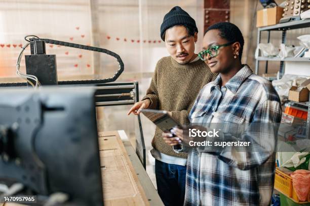 Innovating With Technology Two Students Mastering The Cnc Machine Stock Photo - Download Image Now