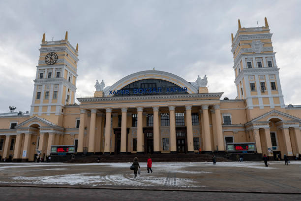 Kharkiv, Ukraine - March 1, 2023: People walk outside the Kharkiv train station on a cold winter afternoon.